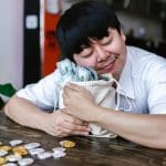 a man hugging a bag of cash money