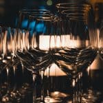 a row of wine glasses on a table 1