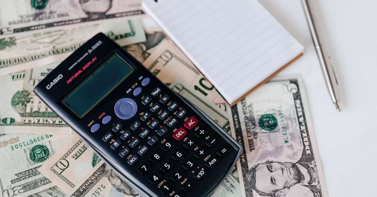 from above electronic calculator and notepad placed over united states dollar bills together with me