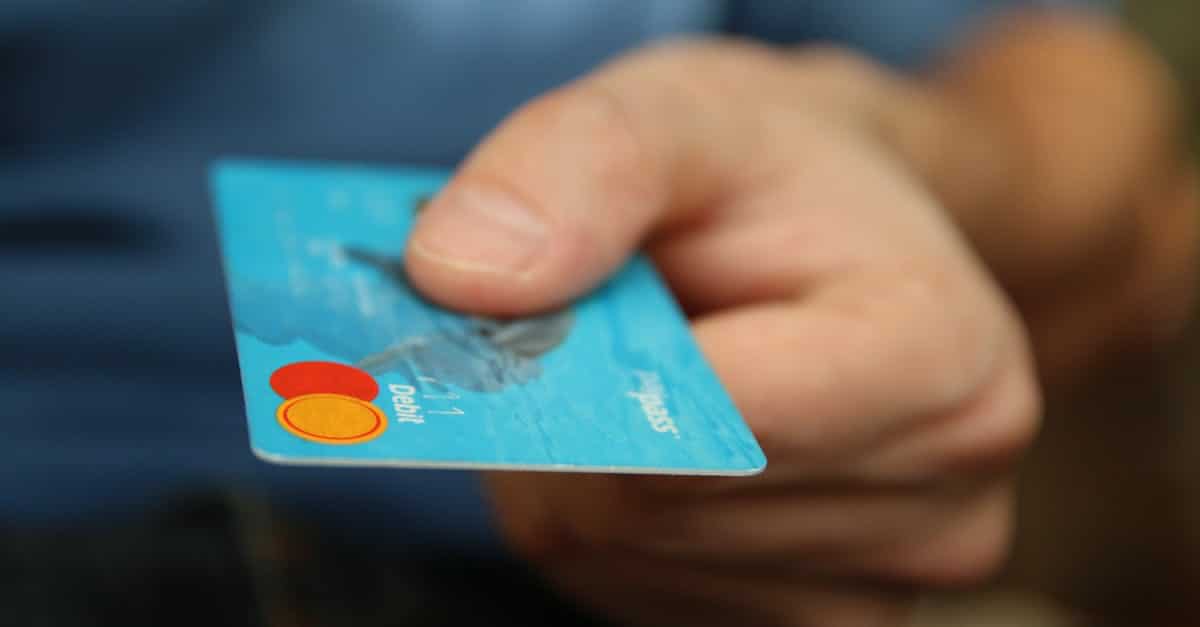 person holding debit card 1