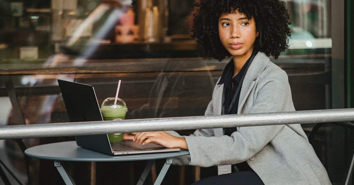 woman in gray blazer sitting near glass window