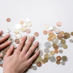 person holding silver round coins