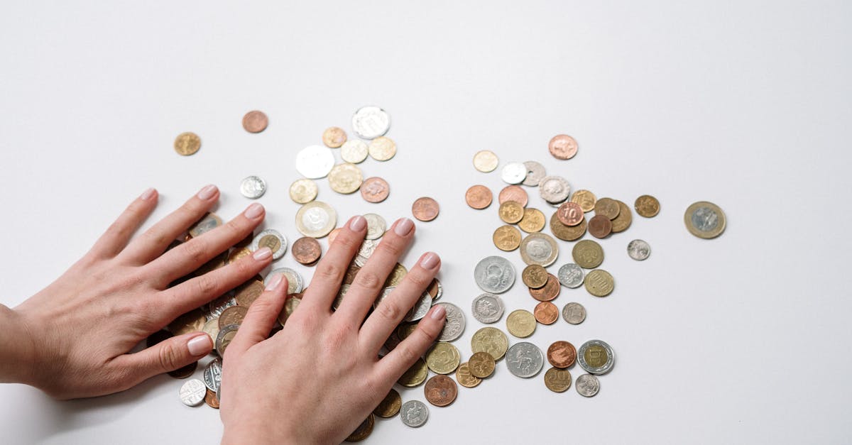 person holding silver round coins