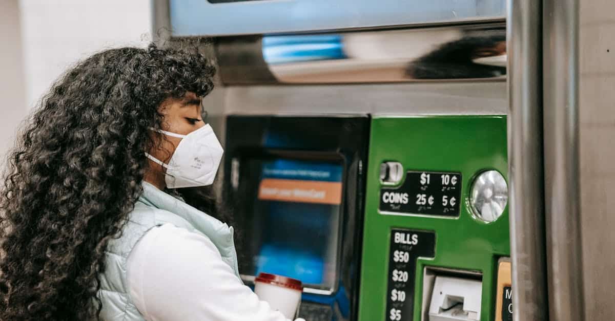 a woman wearing a face mask uses a ticket machine for purchasing fare in a public setting reflectin