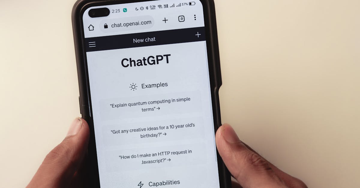 close up of hands holding a smartphone displaying the chatgpt application interface on the screen