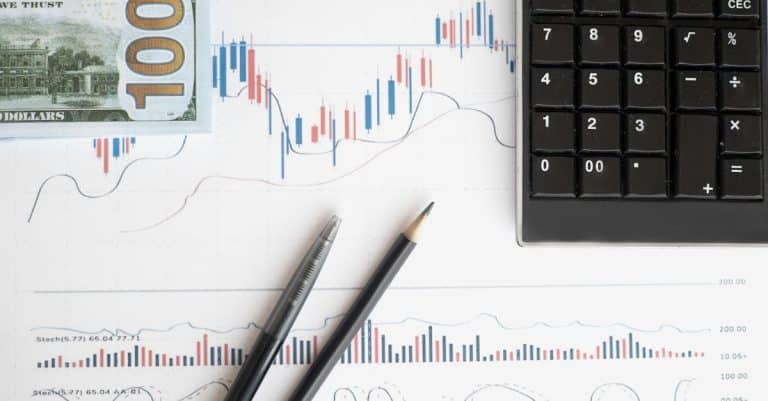 stock-analysis-workspace-featuring-charts-a-calculator-and-currency-for-data-driven-insights